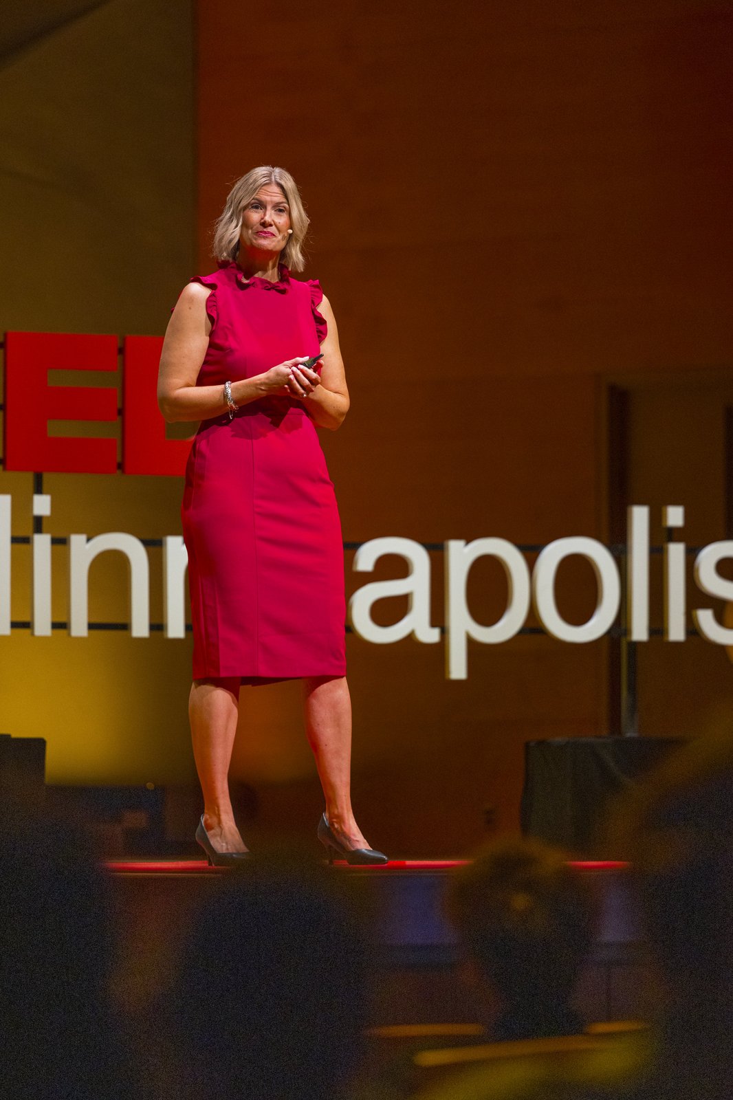 Katherine on stage beside the TEDxMinneapolis lettering