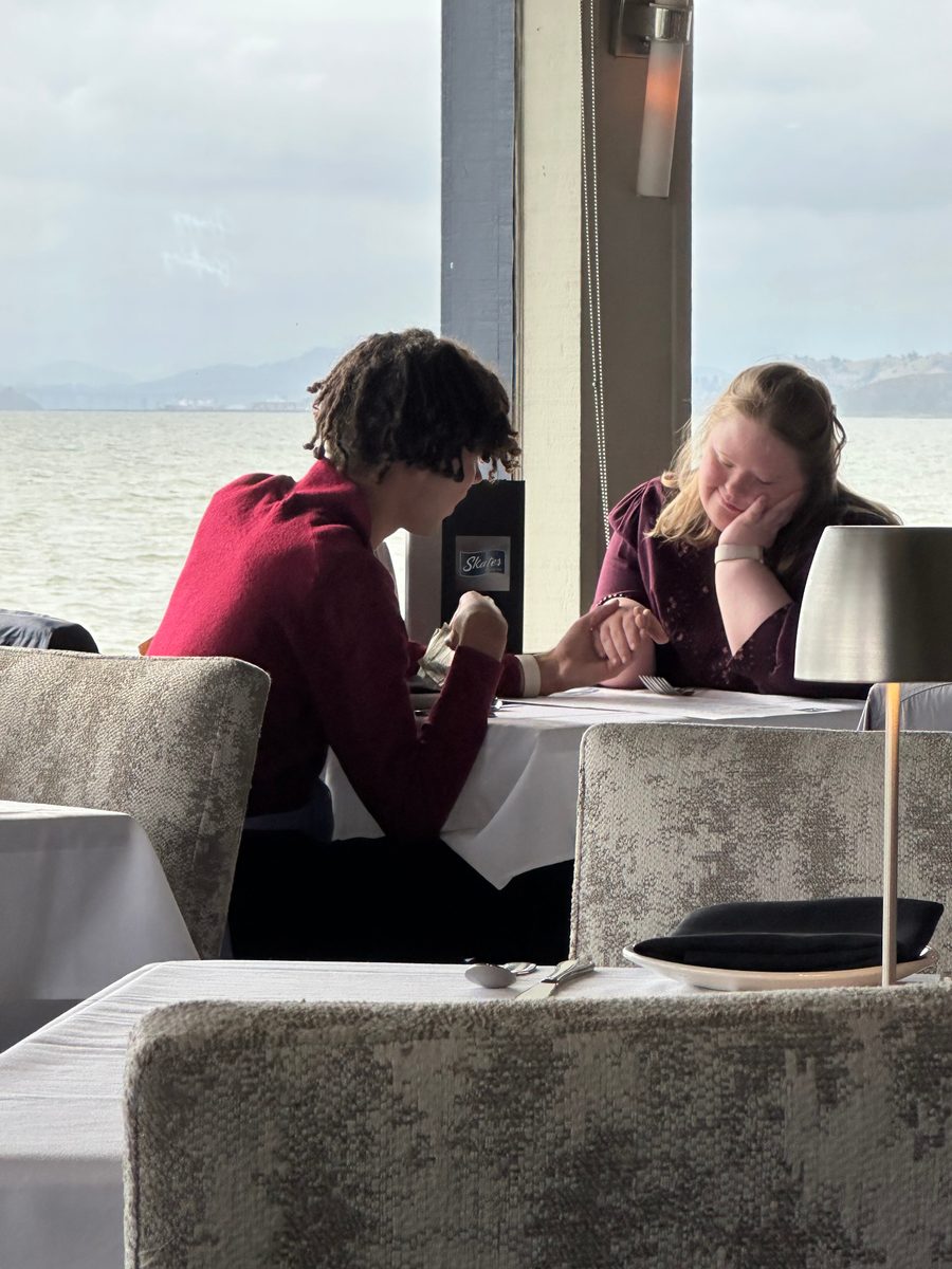 Love and Kailyn holding hands at a bayside restaurant