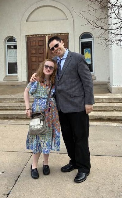 Eric and Maeve standing together outside her church
