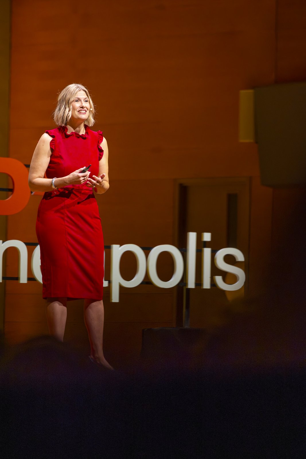 Katherine speaking in front of the TEDxMinneapolis sign