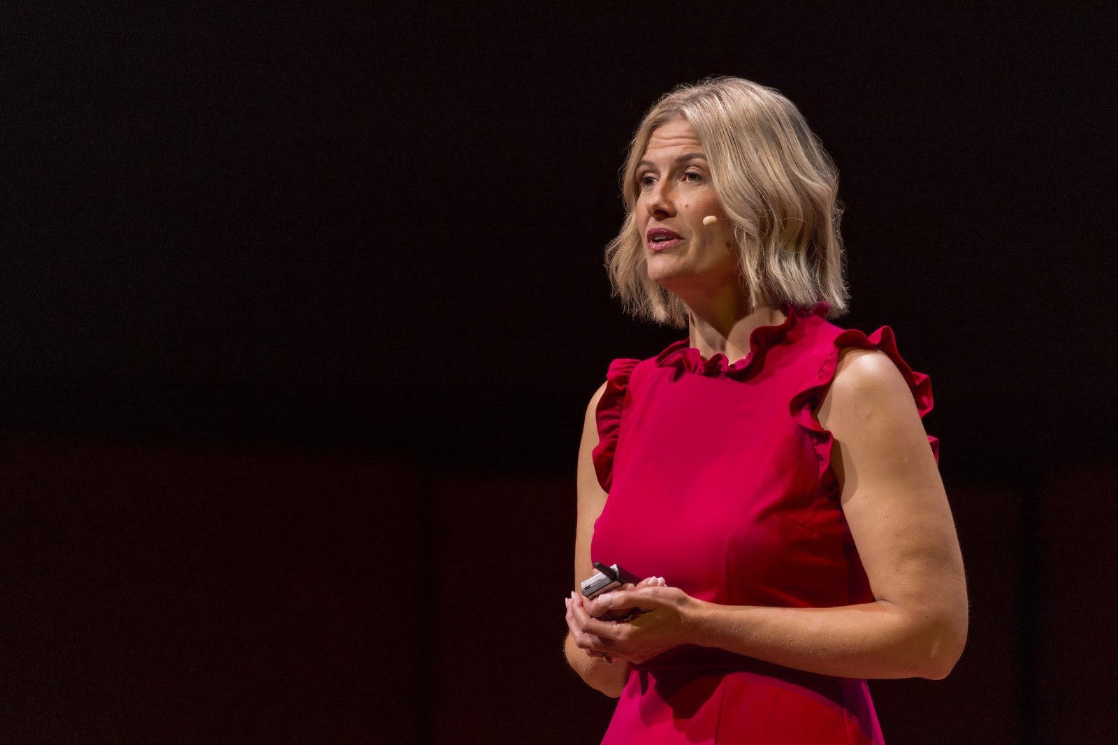 Close portrait of Katherine Gyolai speaking on the TEDxMinneapolis stage