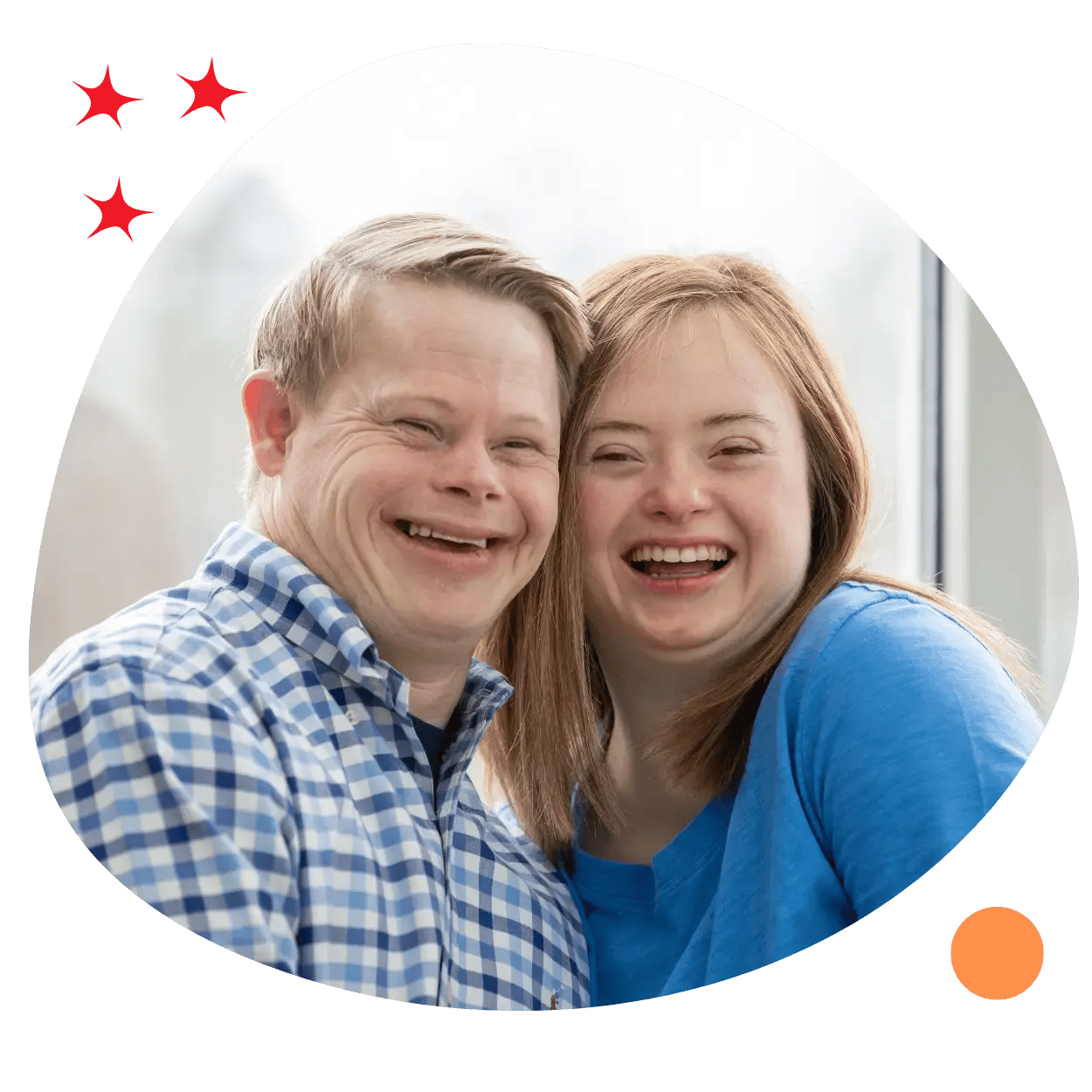 A couple with down syndrome smiling in a happy relationship